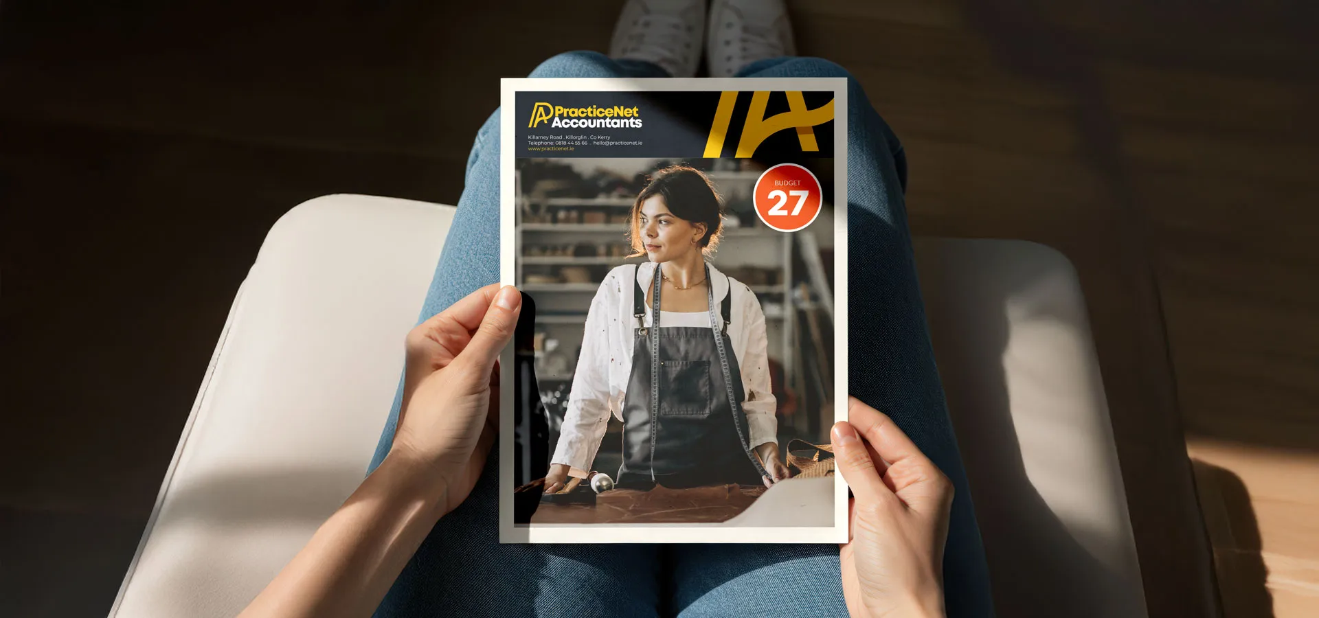 The Budget 2027 summary, branded to an accountancy practice, being read at home